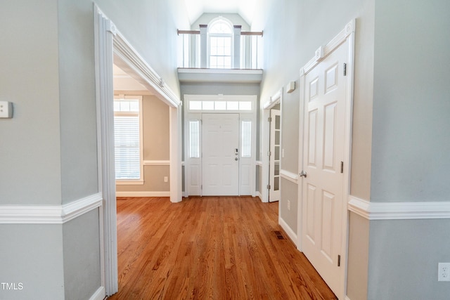 entrance foyer with light hardwood / wood-style flooring and a high ceiling