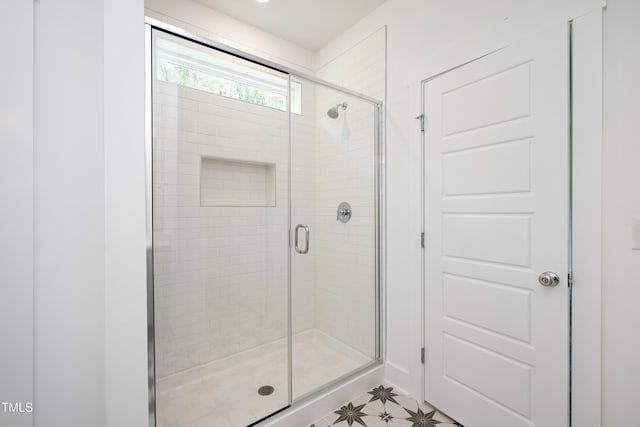 full bathroom featuring a stall shower and tile patterned floors