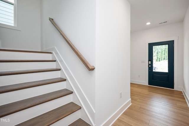 foyer entrance with recessed lighting, visible vents, stairway, light wood-style floors, and baseboards