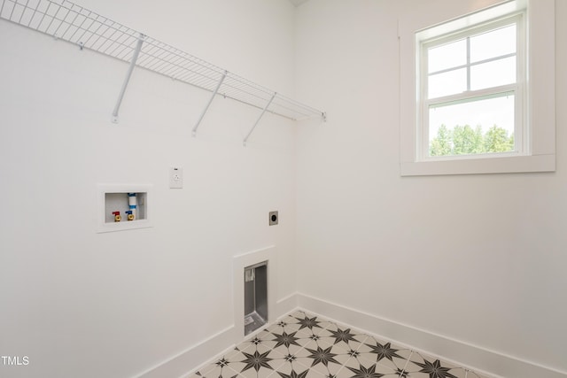 laundry room featuring washer hookup, electric dryer hookup, laundry area, baseboards, and tile patterned floors