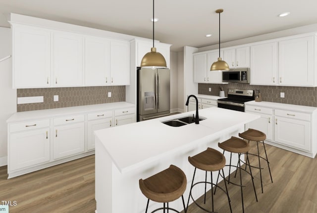 kitchen featuring stainless steel appliances, light countertops, decorative light fixtures, and white cabinets