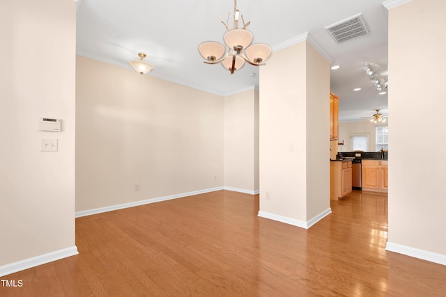 unfurnished room with crown molding, ceiling fan with notable chandelier, and light hardwood / wood-style floors