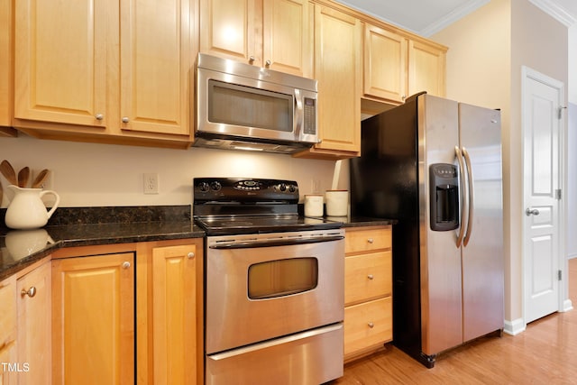 kitchen featuring dark stone counters, stainless steel appliances, crown molding, light brown cabinets, and light hardwood / wood-style flooring