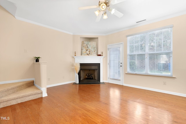 unfurnished living room featuring ceiling fan, ornamental molding, and hardwood / wood-style floors