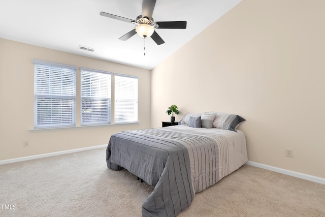 carpeted bedroom with vaulted ceiling and ceiling fan