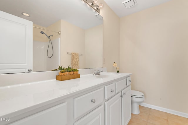 bathroom featuring vanity, a shower, tile patterned floors, and toilet