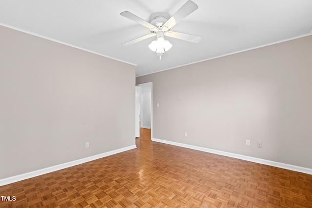 empty room featuring ceiling fan, crown molding, and light parquet flooring