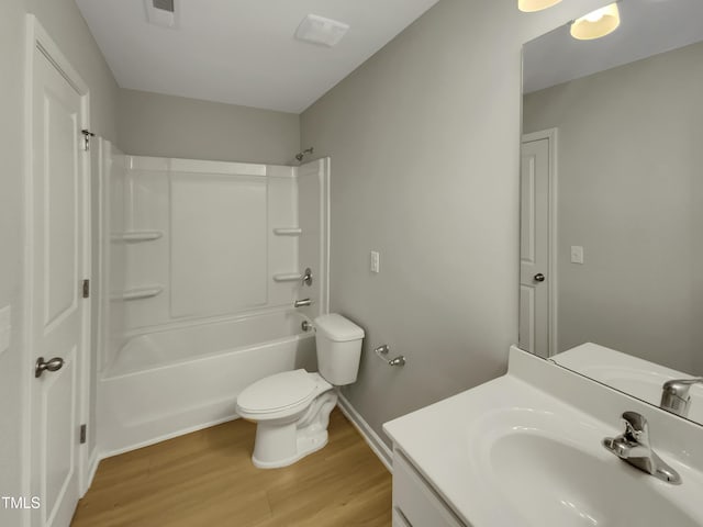 full bathroom featuring wood-type flooring, tub / shower combination, vanity, and toilet