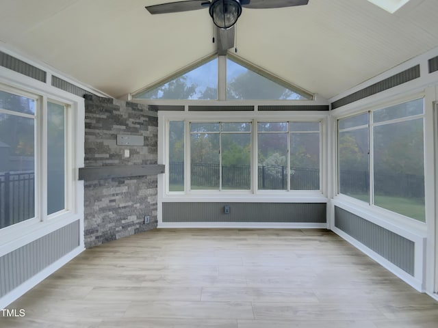 unfurnished sunroom with lofted ceiling and ceiling fan