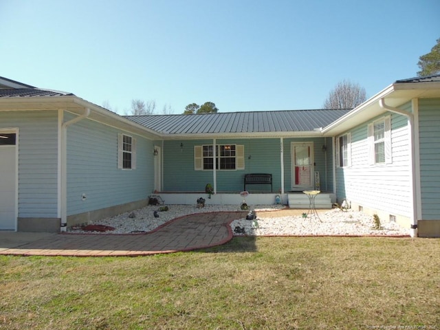 rear view of property with a yard and a porch