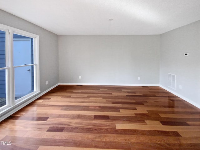 unfurnished room with hardwood / wood-style floors