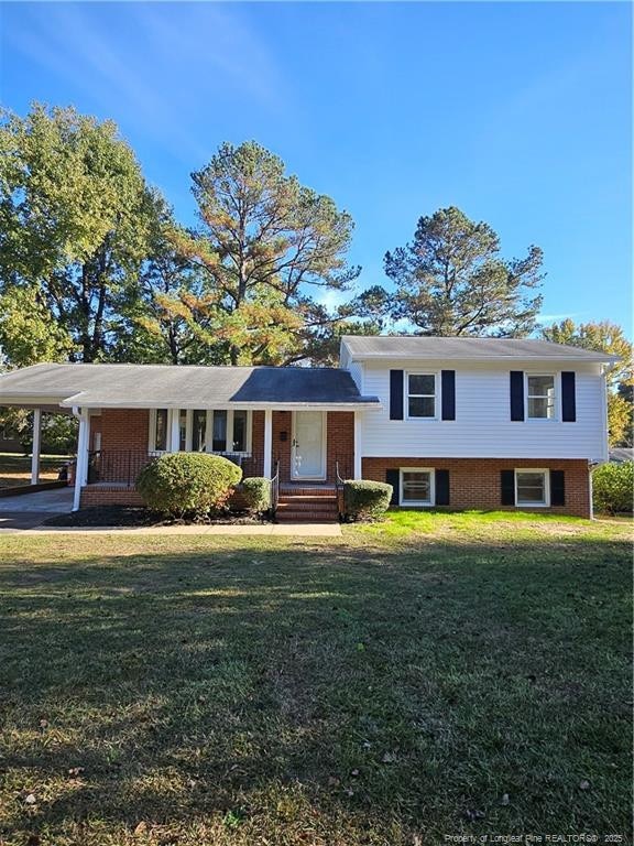 split level home featuring a porch and a front yard