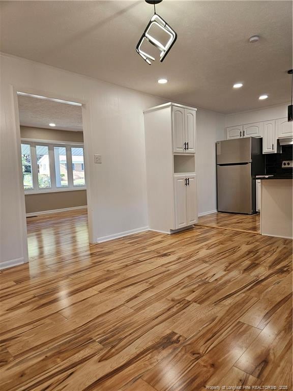 unfurnished living room with light hardwood / wood-style flooring