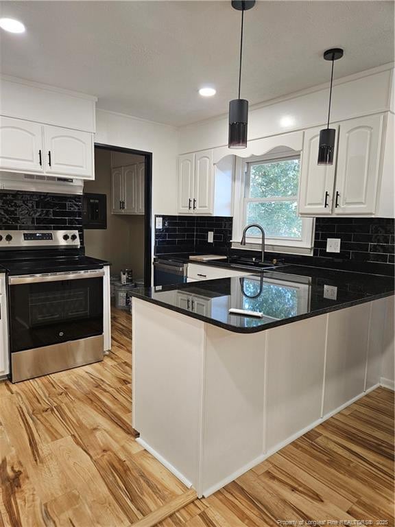 kitchen featuring white cabinetry, decorative light fixtures, light wood-type flooring, and stainless steel electric range oven