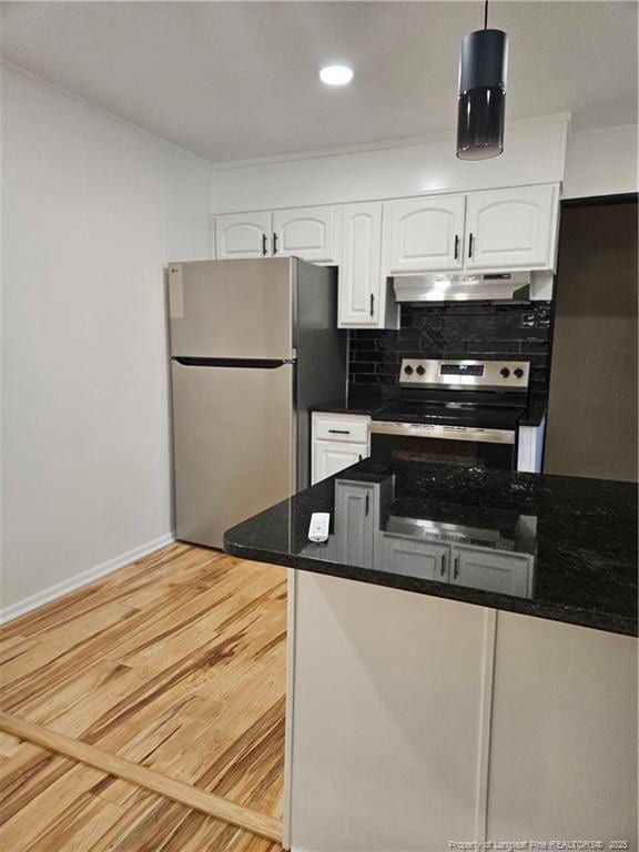 kitchen featuring white cabinetry, decorative light fixtures, stainless steel appliances, light hardwood / wood-style floors, and backsplash