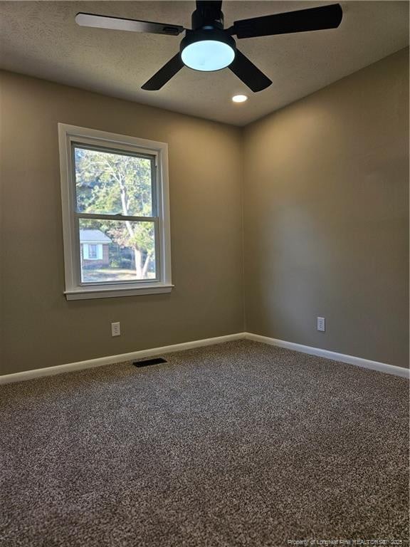 carpeted empty room with a textured ceiling and ceiling fan