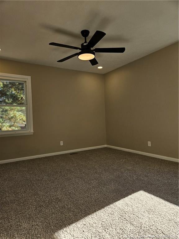 unfurnished room with ceiling fan and carpet flooring