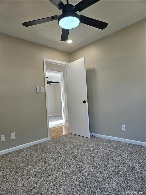 carpeted empty room with ceiling fan