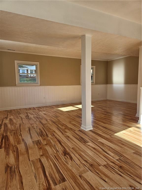 basement with hardwood / wood-style flooring and a textured ceiling