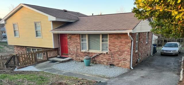 view of front of property featuring driveway and brick siding