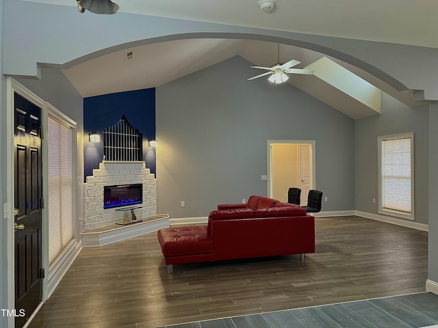 living room featuring ceiling fan, dark hardwood / wood-style floors, and high vaulted ceiling