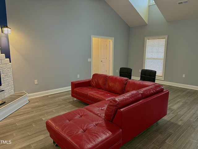 living room featuring hardwood / wood-style flooring and high vaulted ceiling