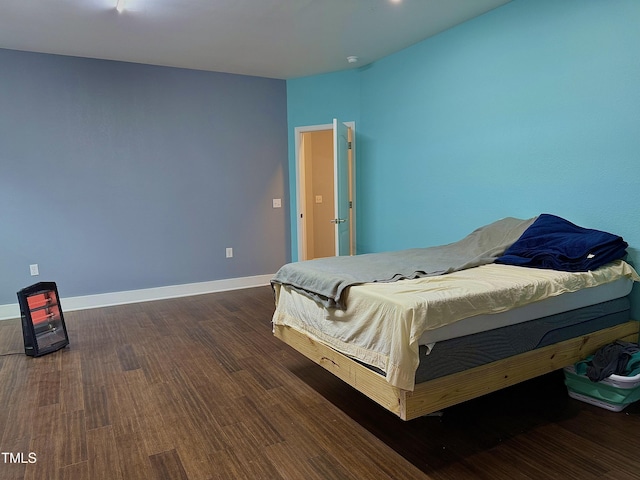 bedroom with dark hardwood / wood-style floors