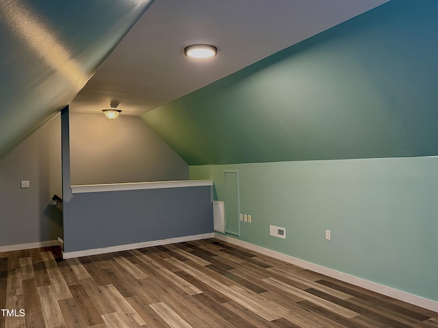 bonus room featuring vaulted ceiling and dark hardwood / wood-style floors