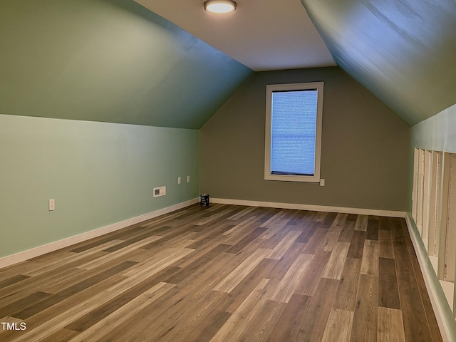 additional living space with lofted ceiling and wood-type flooring