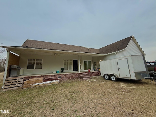 rear view of house with a lawn