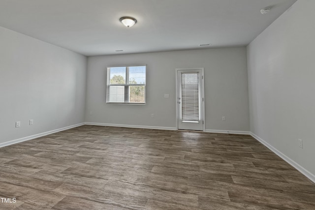 spare room with wood-type flooring