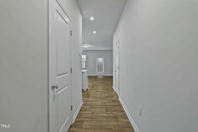 hallway with dark hardwood / wood-style floors