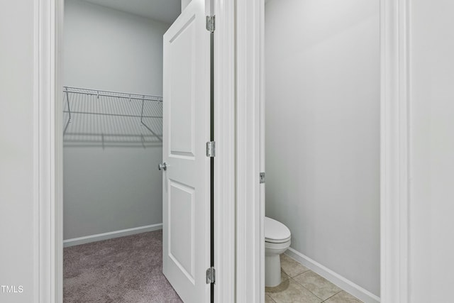 bathroom featuring toilet and tile patterned flooring