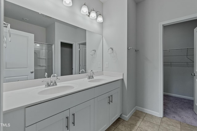 bathroom with vanity, an enclosed shower, and tile patterned floors