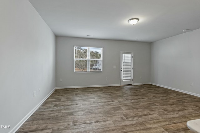 spare room featuring wood-type flooring