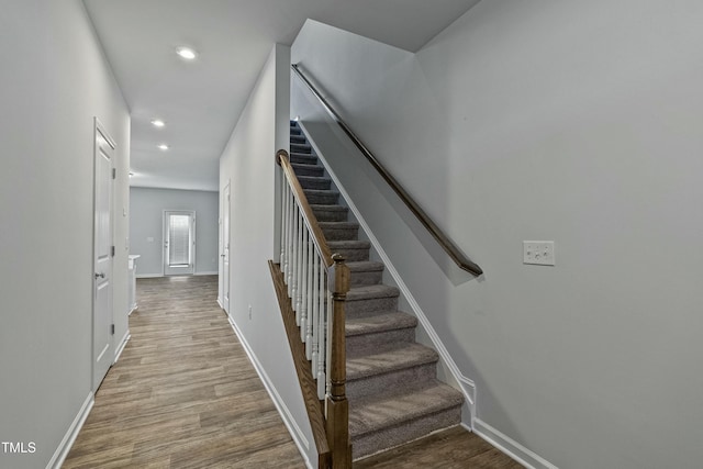 stairs featuring hardwood / wood-style flooring