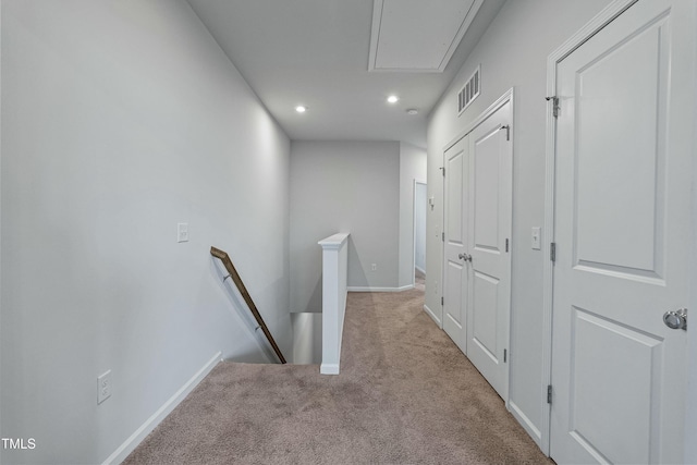 hallway featuring light colored carpet