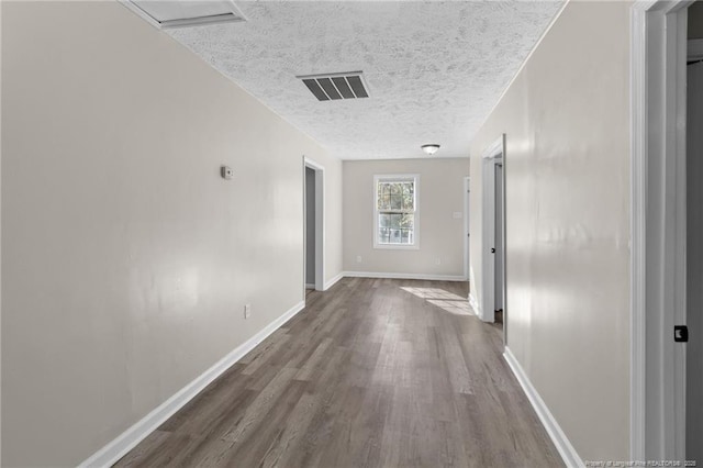 hallway featuring hardwood / wood-style flooring and a textured ceiling