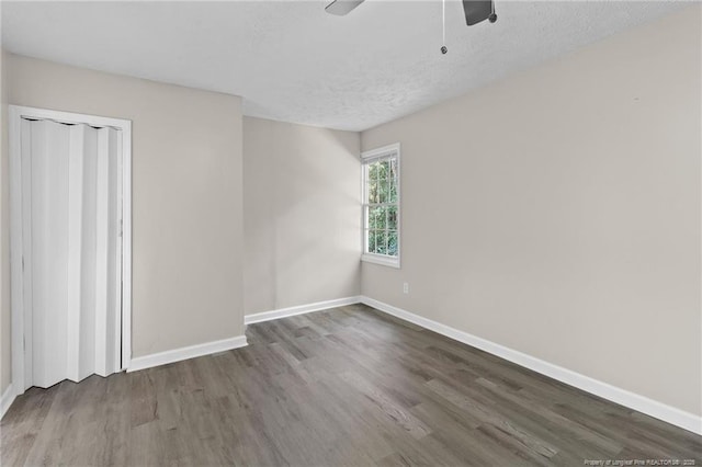 spare room featuring hardwood / wood-style floors, a textured ceiling, and ceiling fan