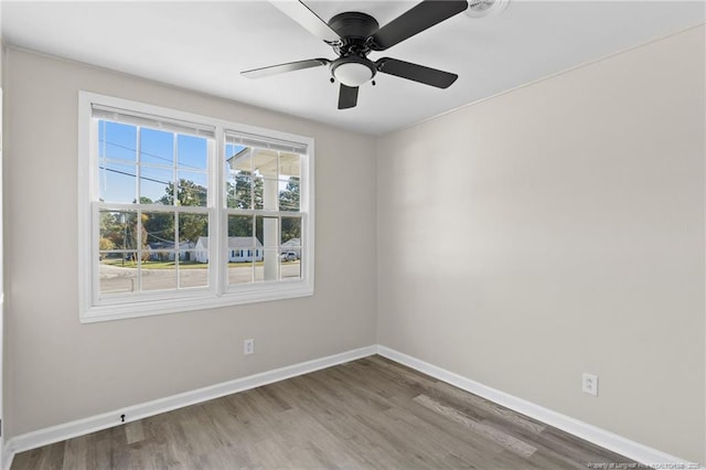 spare room with wood-type flooring and ceiling fan