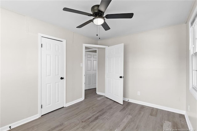 unfurnished bedroom featuring ceiling fan, a closet, and light hardwood / wood-style flooring