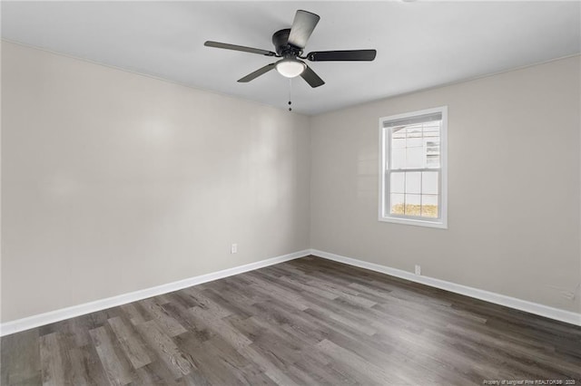 empty room with dark hardwood / wood-style floors and ceiling fan