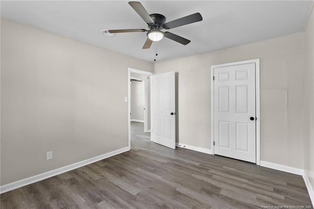 unfurnished bedroom with dark hardwood / wood-style flooring and ceiling fan