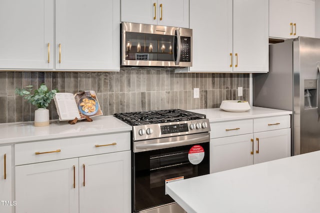 kitchen with white cabinetry, decorative backsplash, and appliances with stainless steel finishes