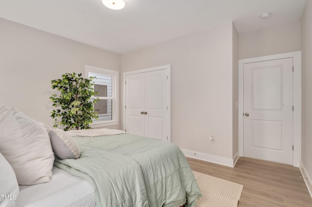 bedroom with a closet and light wood-type flooring