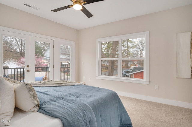 bedroom featuring multiple windows, carpet floors, access to exterior, and french doors