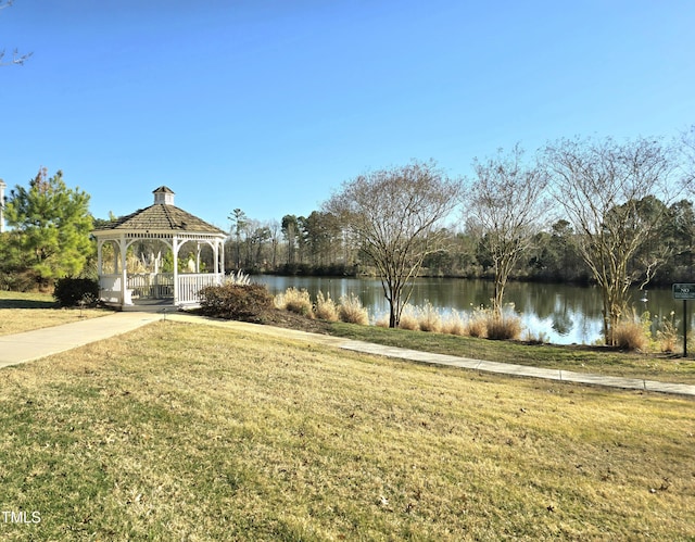 surrounding community with a gazebo, a water view, and a yard