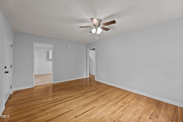 spare room featuring a textured ceiling, ceiling fan, and light hardwood / wood-style flooring