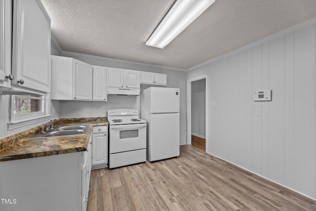 kitchen with white cabinetry, sink, white appliances, and light hardwood / wood-style floors