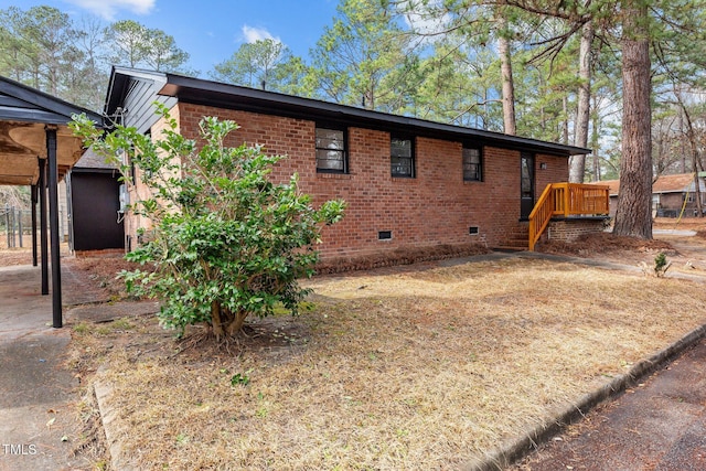 view of side of property featuring a wooden deck